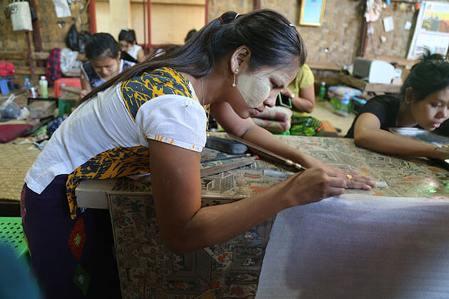an artisan is carving the intricate lacquereware item