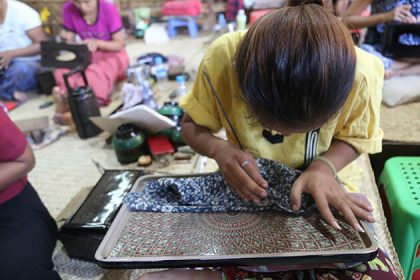 local artisan in lacquerware workshop in bagan